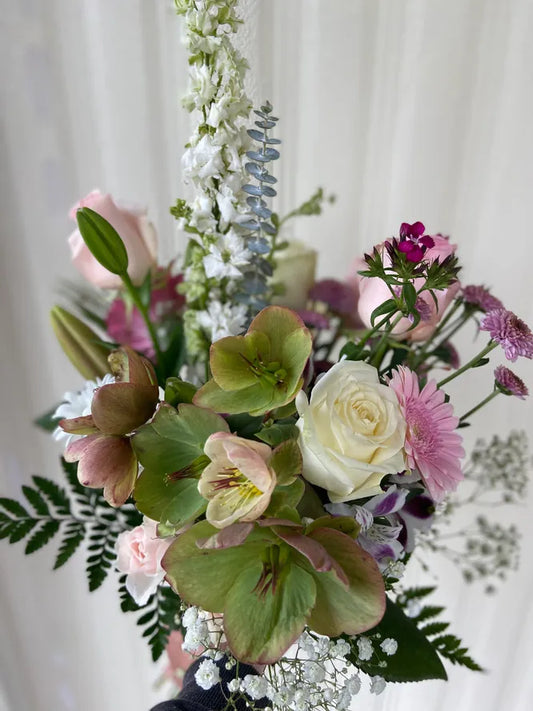 Bouquet with hellebore, roses, mums and delphinium.