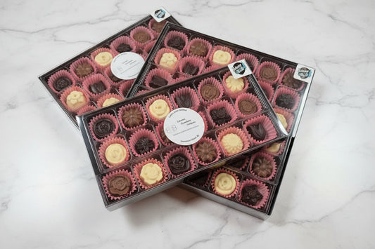 multiple boxes of chocolate flowers 